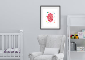 Artwork featured on the wall of a nursery above a rocking chair and crib. The artwork features an illustrated jewel with the words inside "You are more precious than jewels." There is a scattering of illustrated, colored jewels around the image.
