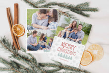 Load image into Gallery viewer, A photo of a double-sided Christmas card showing the front and back of the card laying on a white surface. Around the two sides of the card are pine needles, cinnamon sticks and dried oranges. The front of the card features a photo on the top half of the card with the words “Merry Christmas” in a fun font with illustrated pine trees below the words. Below the pine trees you can customise with your family name. The back of the card features two photos along with illustrated snowflakes and pine trees.