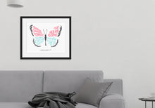 Load image into Gallery viewer, Framed artwork in a black frame on a wall above a grey sofa with a plant next to it. The hand drawn artwork features the scripture verse &quot;Therefore, if anyone is in Christ, the new creation has come. The old has gone. The new is here.&quot; The words are featured inside a butterfly. 