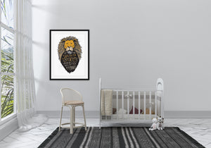 A black frame with artwork featuring a lion's head illustration of Aslan with the quote "At The Sound of Your Roar, Sorrows Will Be No More. The frame is shown above a a crib and chair. 