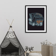 Load image into Gallery viewer, A framed print hangs on a white nursery wall, over baskets of monochrome blankets and a child's play tent. The print features the quote 'Put on the full armour of God' in black and orange typography, with medieval-style pieces of armour illustrated in pale gray.