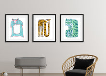 Load image into Gallery viewer, Three black frames on a white wall above a baby cot and chair. The black frames have a blue bear illustration, a giraffe illustration and a a tiger illustration. 