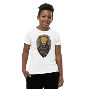 A boy wearing a white short sleeved T-Shirt. The T-Shirt features hand drawn illustration of the Chronicles of Narnia lion character Aslan. Inside the illustration there is the quote “At The Sound of Your Roar, Sorrows Will Be No More.” 
