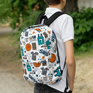 A boy faced with back to camera and a backpack on his shoulders. The backpack has a white background with a basketball themed pattern backpack featuring illustrated basketballs, basketball jerseys, whistles, referee shirts, basketball hoops, stars, basketball shoes, fun play sketches and the word "swish." The backpack straps are black. 