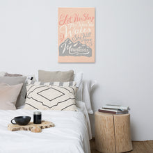 Load image into Gallery viewer, An illustrated pink canvas hangs on a white wall, over a white bed with lots of cushions and pillows. The canvas reads &#39;Let her sleep for when she wakes she will move mountains&#39; in a pink, white, and light grey lettering design, with a grey mountain illustration at the bottom.