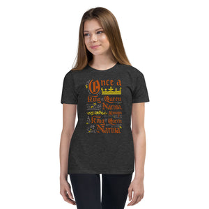 A girl wearing a dark grey short sleeved T-Shirt. The artwork features hand drawn lettering of the Narnia quote "Once a king or queen of Narnia, always a king or queen of Narnia." 