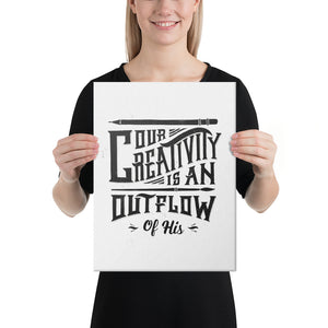A woman holding a canvas in her hands. The canvas has a white background with the words "Our creativity is an outflow of His." The lettering is in black. 