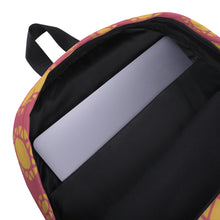 Load image into Gallery viewer, The inside of a backpack showing the laptop pocket. The backpack is on a white background. The backpack features illustrated gems and diamonds in gold on top off a muted hot pink colored backpack. The straps are black. 