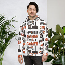 Load image into Gallery viewer, A man wearing a white hoodie featuring different game controllers and the word &quot;gamer&quot; in a repeat pattern throughout the hoodie. The illustrations and gamer word are in red, grey and black. 