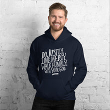 Load image into Gallery viewer, A man wearing a navy hoodie with the Bible verse words Do justly, love mercy, walk humbly, with your God, Micah 6:8 in white lettering. 