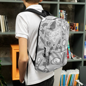 A boy standing in front of a bookshelf with his back to the camera. The backpack is a light gray with a pattern of illustrations in darker gray and white. The pattern of illustrations features test tubes, microscopes, magnifying glasses, protective science goggles, atom models and the words "Science is cool."