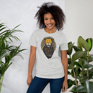 A woman wearing a light grey short sleeved t-shirt. The T-Shirt features hand drawn illustration of the Chronicles of Narnia lion character Aslan. Inside the illustration there is the quote “At The Sound of Your Roar, Sorrows Will Be No More.”