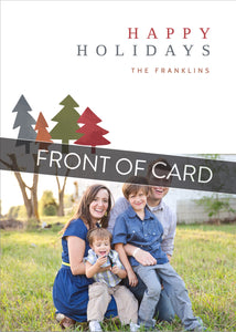 A close up of the front of the card showing the front of the card design. Across the image is a gray strip with the words “front of card” on it. The front of the card features a photo on the bottom and on the top it reads “Happy Holidays, The Franklins” with illustrated modern pine trees. 