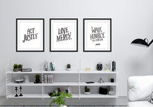 Load image into Gallery viewer, Three black frames featured above a shelving unit in a living room. The first frame features artwork saying &quot;Act Justly.&quot; The second frame says &quot;Love Mercy.&quot; The third frames says &quot;Walk Humbly, with your God - Micah 6:8.&quot;