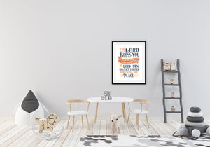 Artwork featured in a nursery room with toys and a kids table. The artwork features hand drawn lettering of the Bible verse Numbers 6:24-26 reading "The Lord bless you and keep you. The Lord make his face to shine on you and be gracious to you. The Lord turn his face toward you and give you peace."