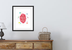 Hand drawn lettering artwork in a black frame over a chest of drawers. The artwork features an illustrated jewel with the words inside "You are more precious than jewels." There is a scattering of illustrated, colored jewels around the image. 