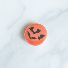 Load image into Gallery viewer, A button on a white tabletop. The button features an illustration of bats.