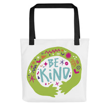 Load image into Gallery viewer, A white tote bag with black handles on a white background. The bag features a design with the words &#39;be kind&#39; with illustrated hugging hands around the words. 