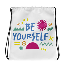 Load image into Gallery viewer, A white drawstring bag on a white background. The drawstring bag has the words &quot;Be Yourself&quot; in blue with green illustrated sketchy pieces around the words. 