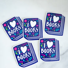 Load image into Gallery viewer, Vinyl die cut stickers featuring the words &quot;I Love Books&quot; inside an illustrated book. 