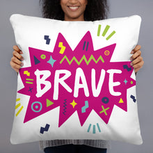 Load image into Gallery viewer, A woman holding a white pillow. The white pillow features the artwork on a white background with a hot pink star with the word &#39;brave&#39; inside and sketchy, fun elements around the word. 