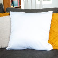 Load image into Gallery viewer, An image showing the back of the pillow on a sofa. The back of the pillow is white. 