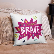 Load image into Gallery viewer, A pillow on the floor on a rug laying against a bed. The white pillow features the artwork on a white background with a hot pink star with the word &#39;brave&#39; inside and sketchy, fun elements around the word. 