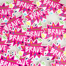 Load image into Gallery viewer, Vinyl die cut stickers with the word &quot;brave&quot; featured inside a pink star-like shape with fun sketchy elements around it. 