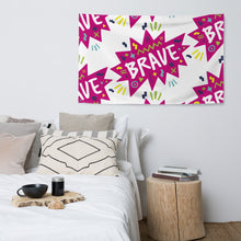 Load image into Gallery viewer, A large flag is featured hanging on the wall of a bedroom above a bed. The white flag features a pattern with the word &quot;brave&quot; featured inside a pink star-like shape with sketchy illustrations around the word. 