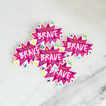 Load image into Gallery viewer, Vinyl die cut stickers with the word &quot;brave&quot; featured inside a pink star-like shape with fun sketchy elements around it. 