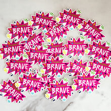 Load image into Gallery viewer, Vinyl die cut stickers with the word &quot;brave&quot; featured inside a pink star-like shape with fun sketchy elements around it. 