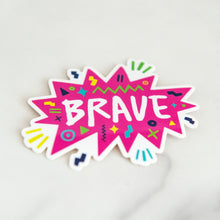 Load image into Gallery viewer, A vinyl die cut sticker with the word &quot;brave&quot; featured inside a pink star-like shape with fun sketchy elements around it.