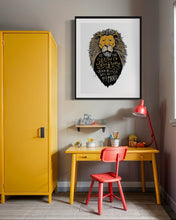 Load image into Gallery viewer, Artwork in a black frame with the with a white matte. The frame is on a wall above a a kids desk. The artwork features an illustrated Aslan (the lion from Chronicles of Narnia). Inside the lion the Narnia quote is featured reading “At The Sound of Your Roar, Sorrows Will Be No More.”