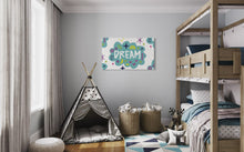 Load image into Gallery viewer, A large flag featured on the wall of a kids room. The white flag features a pattern with the word &quot;dream&quot; featured inside a cloud with sketchy illustrations around the word. 