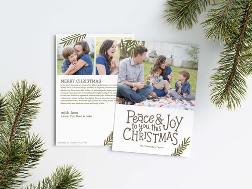 A photo of a Christmas card showing the front and back of the card laying on a white surface. Around the two sides of the card are pine needles. The front of the card features a photo on the top portion and the words “Peace & Joy to You This Christmas” with space to put your family name below. The back side of the card features two photos with space to write a yearly update. 