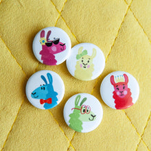 Load image into Gallery viewer, A set of five buttons on a yellow background. The buttons feature five different colorful, illustrated llamas. 