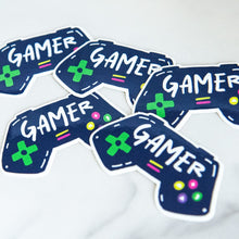 Load image into Gallery viewer, Vinyl die cut stickers with the word &quot;gamer&quot; inside an illustrated game contoller.