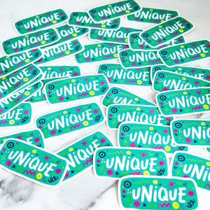 Vinyl die cut stickers with the word "unique" and sketchy elements surrounding the word. 