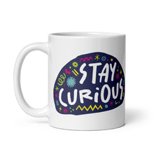 Load image into Gallery viewer, A white ceramic mug on a white background. The mug features a design with the words &#39;stay curious&#39; in an illustrated oval shape with sketchy elements around it. 