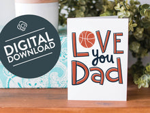 Load image into Gallery viewer, A greeting card is on a table top with a present in blue wrapping paper in the background. On top of the present is a candle and some greenery from a plant too. The card features the words  “Love you Dad” with an illustrated basketball as the “O” of love. The words &quot;digital download&quot; are featured in a circle on top of the image. 