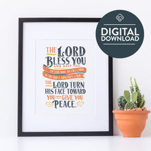 Load image into Gallery viewer, The words &quot;digital download&quot; are featured over the image. Artwork in a black frame with the with a white matte. The frame is leaning on a white counter with a terracota pot with a catcus next to it. The artwork features hand drawn lettering of the Bible verse Numbers 6:24-26 reading &quot;The Lord bless you and keep you. The Lord make his face to shine on you and be gracious to you. The Lord turn his face toward you and give you peace.&quot;