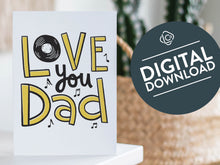Load image into Gallery viewer, A card on a wood tabletop with an object in the background that is out of focus. The card features the words “Love you Dad” with a vinyl record as the “O” of love and music notes around the letters. The words &quot;digital download&quot; are featured in a circle on top of the image. 