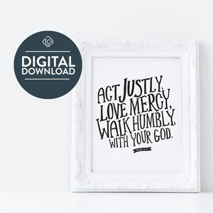 The words "digital download" are featured over the image. Artwork in a white frame with the with a white matte. The frame is leaning on a white counter. The artwork features hand drawn lettering reading "Act Justly, Love Mercy, Walk Humbly with your God" - Micah 6:8.