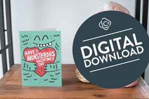 A card on a wood tabletop and on the right side of the card is a woven basket, a pink plant pot with a cactus in it and a pink crystal rock. The card features the words “Have a monstrous Valentine’s Day” with an illustrated monster holding a heart..  The words "digital download" are featured in a circle on top of the image. 