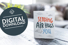 Load image into Gallery viewer, A greeting card featured on a black, wood coffee table. There’s a white planter in the background with a green plant. There’s also a gray sofa in the background with a white pillow. The card features the words “Sending air hugs to you.”. The words &quot;digital download&quot; are featured in a circle on top of the image.