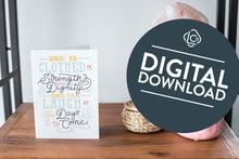 Load image into Gallery viewer, A card on a wood tabletop and on the right side of the card is a woven basket, a pink plant pot with a cactus in it and a pink crystal rock. The card features the words &quot;She is clothed in strength and dignity; she can laugh at the days to come.&quot;  The words &quot;digital download&quot; are featured in a circle on top of the image. 
