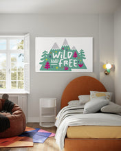 Load image into Gallery viewer, A large white flag featured on a wall of a teens&#39; bedroom. The white flag features the words &#39;wild and free&#39; inside illustrated mountains with sketch trees and other elements around.