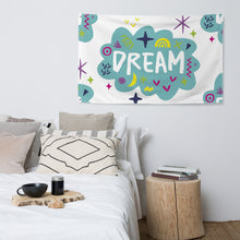 Load image into Gallery viewer, A large flag is featured hanging on the wall of a bedroom above a bed. The white flag features a pattern with the word &quot;dream&quot; featured inside a cloud with sketchy illustrations around the word. 