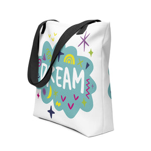 A side view of a white tote bag with black handles on a white background. The bag features a design with the word 'dream' with an illustrated cloud around the word with colorful sketchy around. 