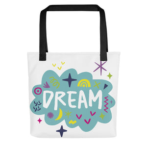 A white tote bag with black handles on a white background. The bag features a design with the word 'dream' with an illustrated cloud around the word with colorful sketchy around. 